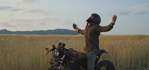 Bearded man on old cafe racer motorcycle in wheat field Stock Footage 140622902