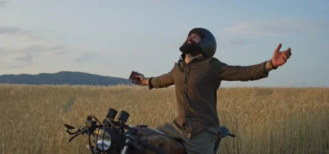 Bearded man on old cafe racer motorcycle in wheat field Stock Footage 140622964