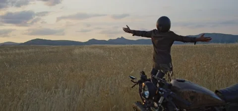 Bearded man on old cafe racer motorcycle in wheat field Stock Footage 140678945