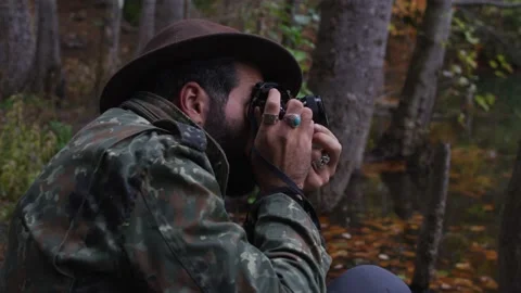 Bearded man with old camera in autumn forest near a lake Stock Footage 138122475