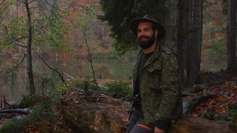 Bearded man with old camera in autumn forest near a lake Stock Footage 138123029
