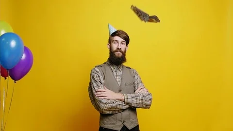 Bearded man in party hat catches dollars 스톡 동영상 81697384