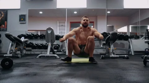 The bearded man performs the jump from the shoulder blades in the gym. Intense Stock Footage 156471772