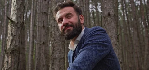 Bearded man in pine forest, standing and enjoying air Stock Footage 140265897