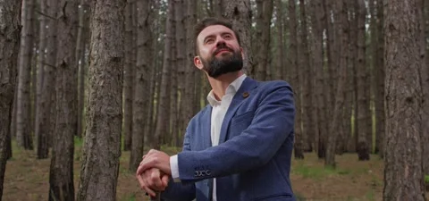 Bearded man in pine forest, standing and enjoying air Stock Footage 140265990
