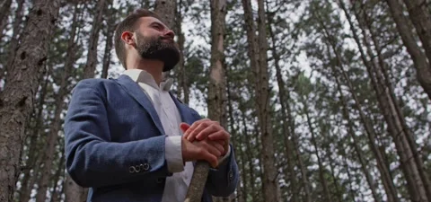 Bearded man in pine forest, standing and enjoying air Stock Footage 140266574