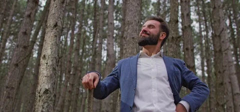 Bearded man in pine forest, standing and enjoying air Stock Footage 140267039