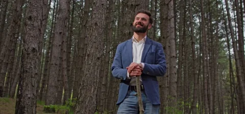 Bearded man in pine forest, standing and enjoying air Stock Footage 140267058