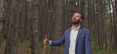 Bearded man in pine forest, walking and enjoying air Stock Footage 140265977