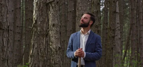 Bearded man in pine forest, walking and enjoying air Stock Footage 140268188