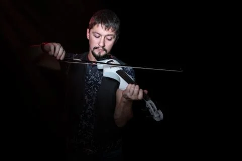 Bearded man playing on electroviolin Stock Photos