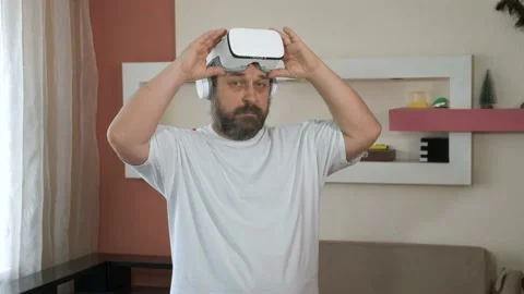 Bearded man playing game in vr glasses, touch something using modern virtual Stock Footage 130359672