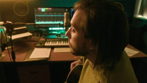 Bearded Man Playing Guitar and Recording Song on Computer App Stock Footage 303102626