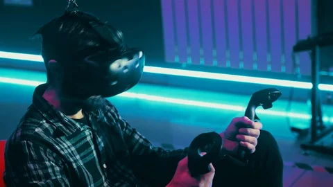 Bearded man playing a vr game using modern virtual reality headset with gamepad Stock Footage 113426978