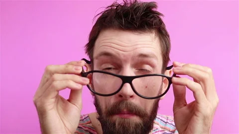 Bearded man with poor eyesight put on glasses close up Stock Footage 135883798