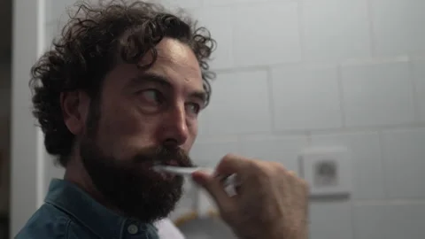 Bearded man practicing daily dental hygiene routine Stock Footage 336624608