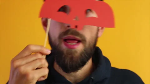 Bearded man with pumpkin face paper mask singing happy halloween close up Stock Footage 138479304