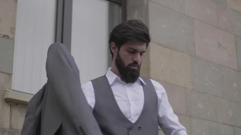 Bearded man puts on jacket blond lady comes up to ramp Stock Footage 103935179