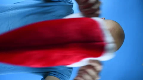 Bearded man puts on a Santa hat, vertical video Stock Footage 141531761
