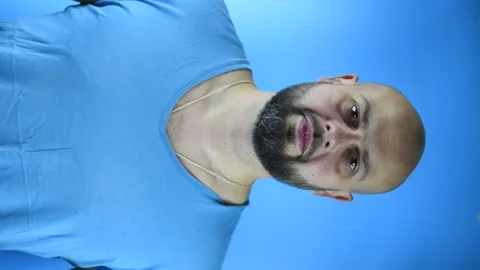 Bearded man puts on a Santa hat, vertical video Stock Footage 141684762