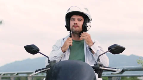 A bearded man puts on a white helmet. Stock Footage 312867811