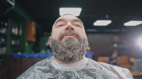Bearded man raises his head and looks into the camera. Stock Footage 144668104