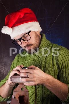 Bearded man in a red Santa hat Stock Photos