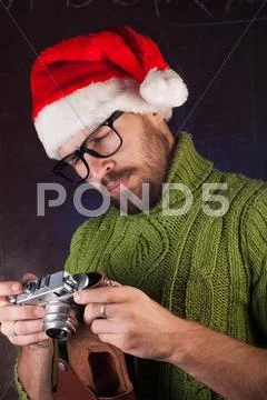Bearded man in a red Santa hat Stock Photos