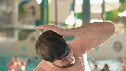 Bearded man resting in indoor aqua park. Stockbeeldmateriaal 102877802