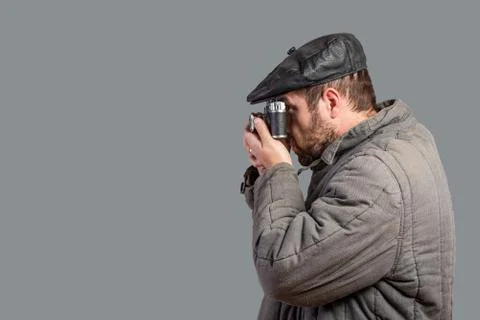 Bearded man with retro camera, studio shott. Old-fashioned clothing style. Co Stock Photos