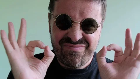 Bearded Man in round Eyeglasses Looking to Camera, ShowThump Up Stock Footage 111575251