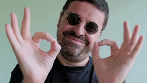 Bearded Man in round Eyeglasses Looking to Camera, ShowThump Up Stock Footage 111575509