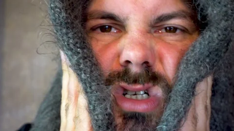 A bearded man rubs his cheeks with a woolen shawl 4K Stock Footage 118675860