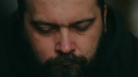 Bearded man sadly looking at the camera Stock Footage 195993370