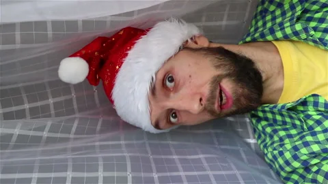 Bearded man  in santa hat look out the curtain merry christmas  happy new year Stock Footage 142675369