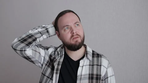 Bearded man scratching his head, expressing confusion and deep thought Stock Footage 300082836