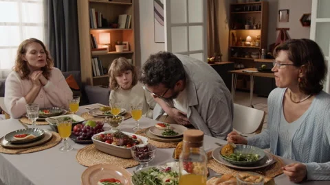Bearded Man Serving Hot Meal to Family at Dinner Table Stock Footage 340342176