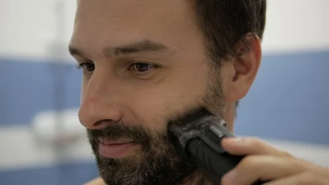 Bearded man shaving trimmer Stock Footage 98134750