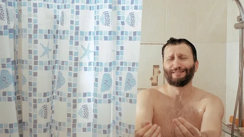 Bearded man in shower asks for phone, female hand gives man smartphone and he Видео 124355124