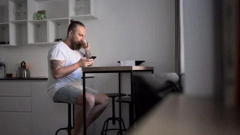 Bearded man sit and read news on phone Stock Footage 110905476