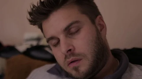 Bearded man sleeping sitting Stock Footage 83136780