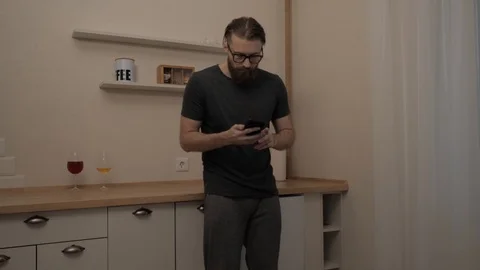 Bearded man with smartphone dancing Stock Footage 104304692