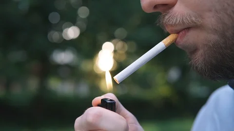 Bearded man smokes a cigarette on background evening lights city Stock Footage 129810085