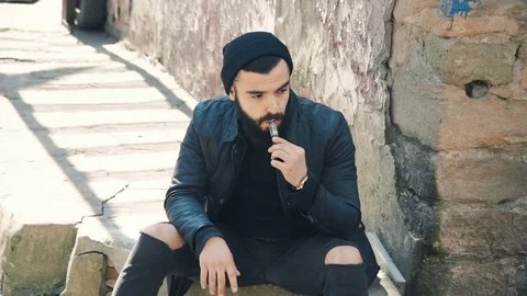 Bearded man smokes electronic cigarette 動画素材 74137721