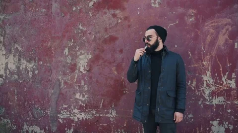 Bearded man smokes electronic cigarette Stock Footage 74142177