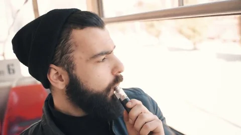 Bearded man smokes electronic cigarette Stock Footage 74142321