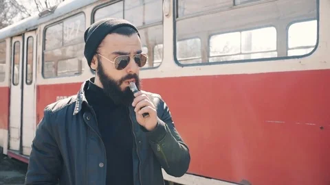 Bearded man smokes electronic cigarette Stock Footage 74142541