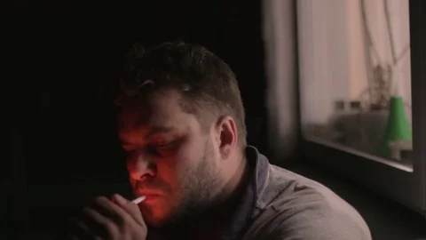 Bearded man smoking in darknes Stock Footage 83136794