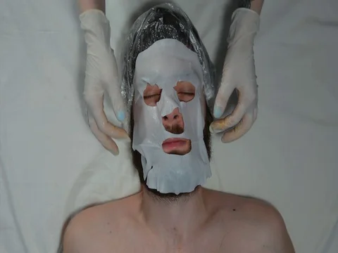 Bearded man in a spa with a mask on his face Stock Footage 128705665