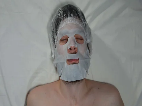 Bearded man in a spa with a mask on his face Stock Footage 128705666